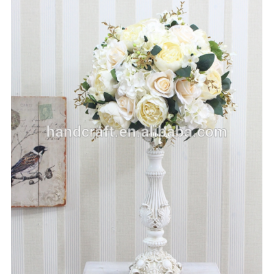 Centerpiece flower arrangement with white rose cascading over the side dripping crystal beads and roses